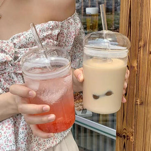 Glass straw cup with dome lid filled with iced coffee