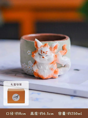 Hand-sculpted ceramic coffee cup from Artisan Series with whimsical 3D details and textured finish
