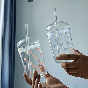 Household glass cup with heart and bow design and matching straw