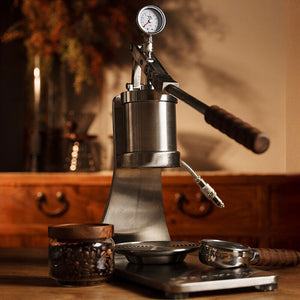 Aleman 2s Hand Press Espresso Machine with polished stainless steel and wooden base