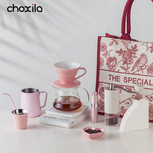 Choxila Pink Pour-Over Coffee Set with kettle, ceramic dripper, glass server, grinder, scale, filters, cup, bean bowl, mister, and floral travel bag.