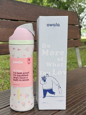 Pink Owala water bottle with a floral print and pastel accents