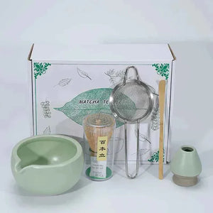 Japanese matcha tea set with ceramic bowl, whisk, sifter, and bamboo scoop.