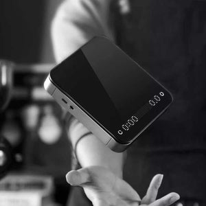 HARIO Smart Electronic Scale with dual LED display, polished glass surface, silver metallic frame, and silicone anti-slip pad for precise coffee brewing.