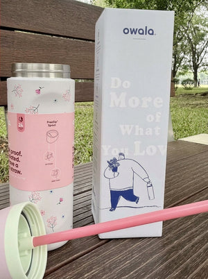 Insulated water bottle with straw from Owala in a pink floral colorway