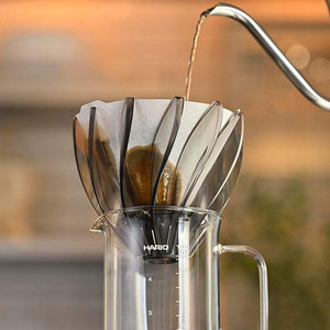 HARIO Water Lily V60 coffee dripper with petal design and smoky transparent finish on black base