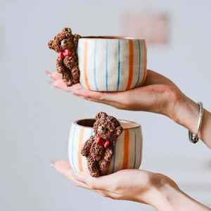 Hand-sculpted ceramic coffee cup from Artisan Series with whimsical 3D designs and textured finish