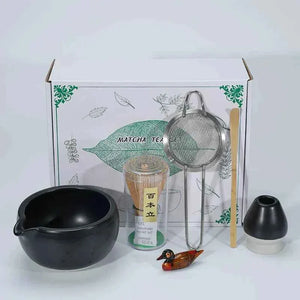 Japanese Maccha tea set with bowl, whisk, strainer, and decorative items.