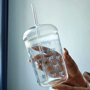 Household glass cup with heart and bow design and matching straw