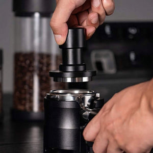 IKAPE calibrated espresso tamper shown from the side with wide leveling rim