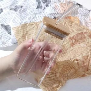 Transparent minimalist borosilicate glass highball cup with bamboo lid and glass straw for iced coffee