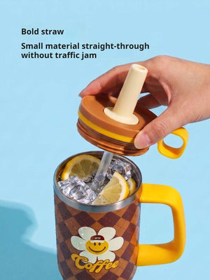 Hand holding the straw above the Brown tumbler filled with ice and lemon