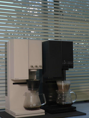 Side-by-side comparison of xBloom Studio in Midnight Black and Starlight White colors.
