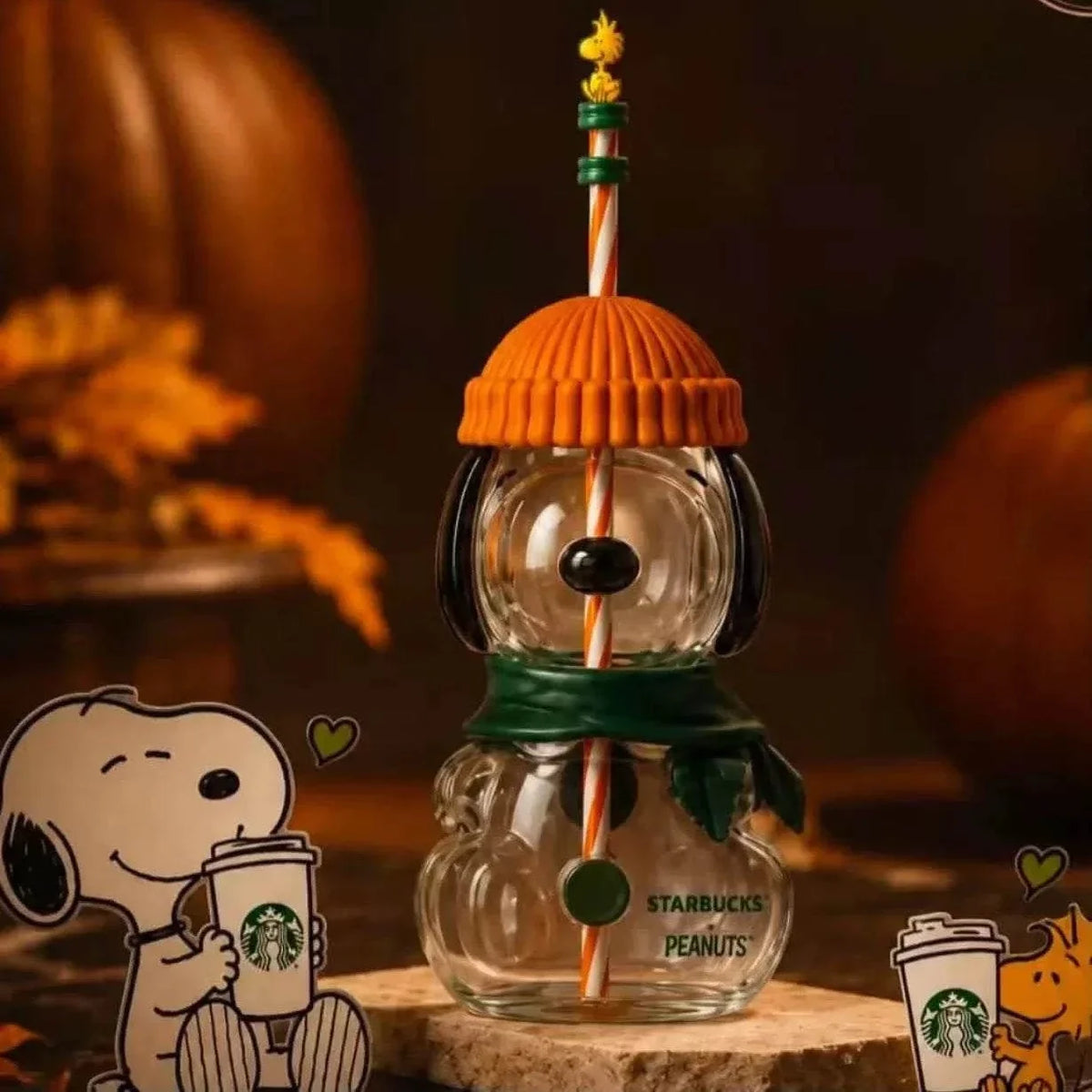 Starbucks Snoopy glass cold cup 2026 with orange beanie lid, green scarf and Woodstock straw topper