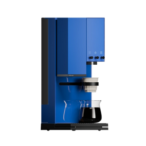 xBloom Studio in blue brewing pour-over coffee into a glass carafe, side view