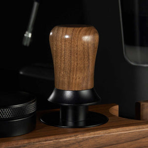 Espresso tamper with ergonomic wooden handle and stainless steel ripple base for even coffee extraction