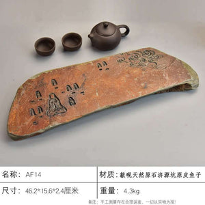 Handcrafted natural stone tea tray with traditional carvings and rustic ochre tones for Gongfu tea ceremony