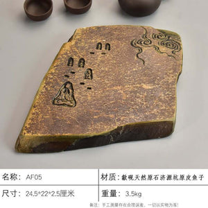 Handcrafted natural stone tea tray with intricate carvings and rustic ochre tones for Gongfu tea ceremony