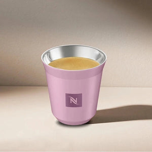 Pink Nespresso Swarovski espresso cup filled with coffee, angled view