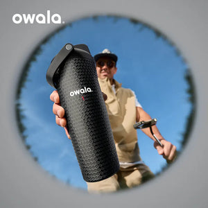 Person holding the Owala Out of Bounds golf bottle with golf club