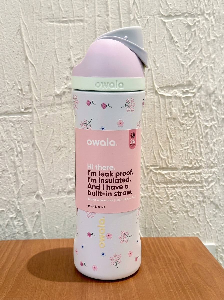 Owala FreeSip insulated water bottle with straw in a pink floral pattern