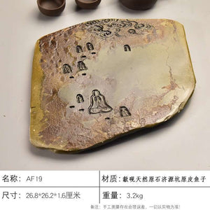 Handcrafted natural stone tea tray with carved traditional motifs and rustic ochre tones for Gongfu tea ceremonies