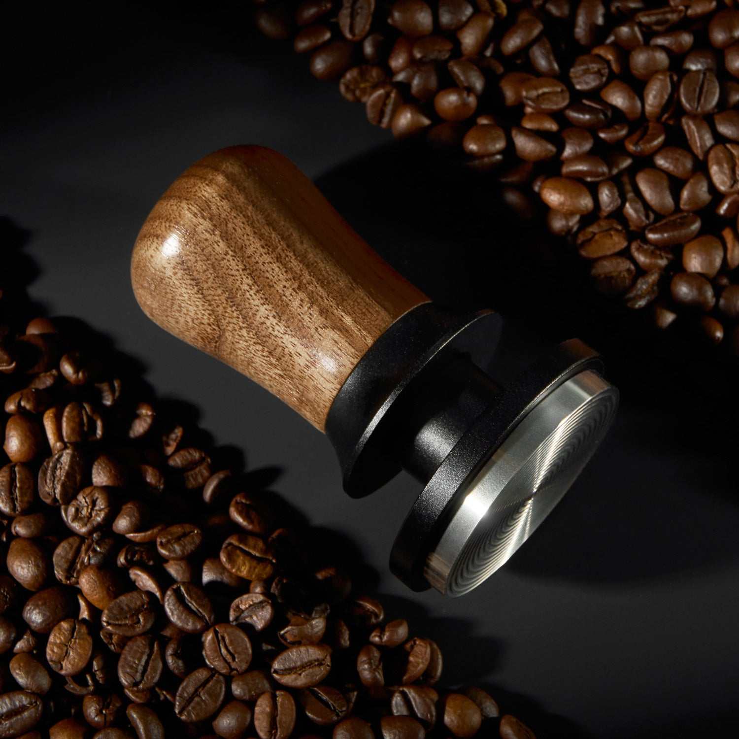 Espresso tamper with natural wood handle and ripple stainless steel base for even coffee extraction