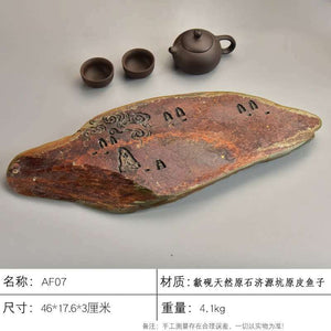 Handcrafted natural stone tea tray with intricate meditative carvings and rustic ochre tones for Gongfu tea ceremony