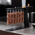 Magnetic coffee bean storage tubes with metal stand and stainless steel funnel on kitchen counter