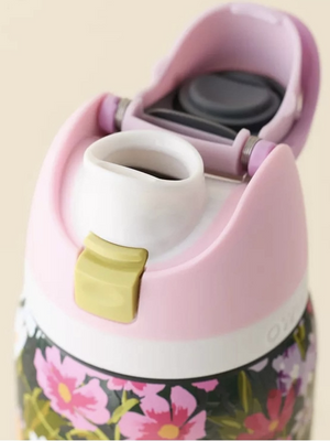Owala FreeSip pink lid opened showing dual drinking spout and straw