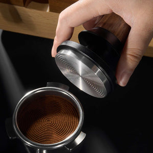 Espresso tamper with natural wood handle and ripple stainless steel base for even coffee extraction