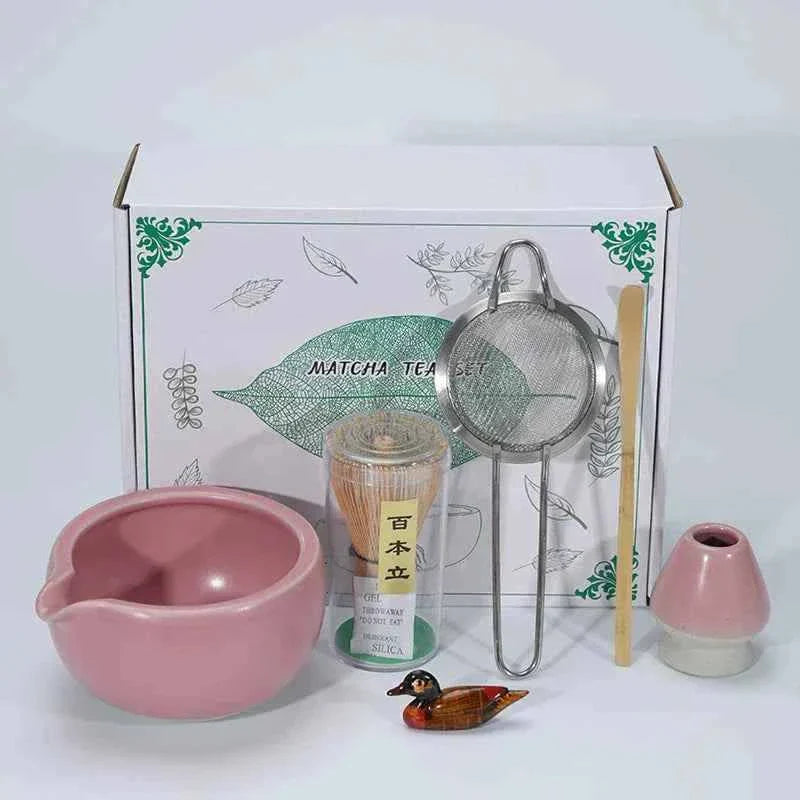 Maccha Japanese ceramics tea set with whisk, strainer, and accessories displayed in front of a decorative box.