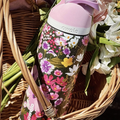Owala FreeSip floral print water bottle in wicker basket with flowers