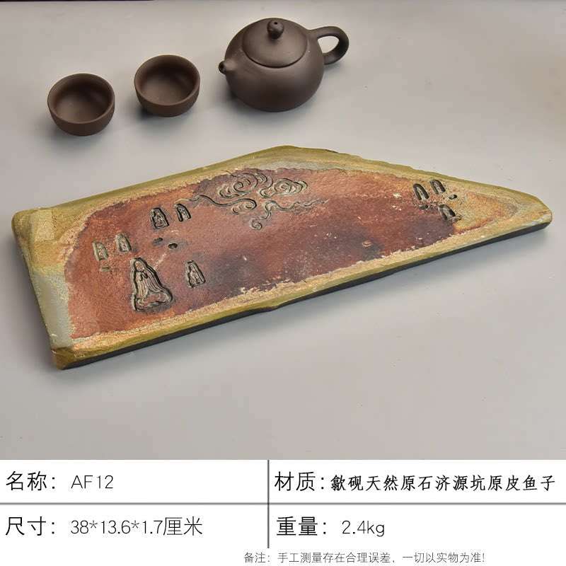 Handcrafted natural stone tea tray with intricate She Yan carvings and rustic ochre texture for Gongfu tea ceremony