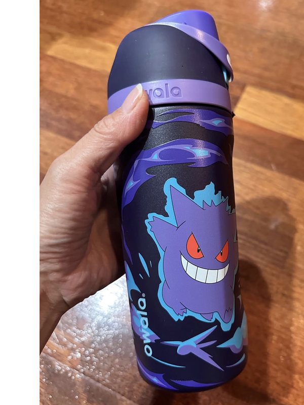Hand holding Owala Gengar water bottle in purple, side view