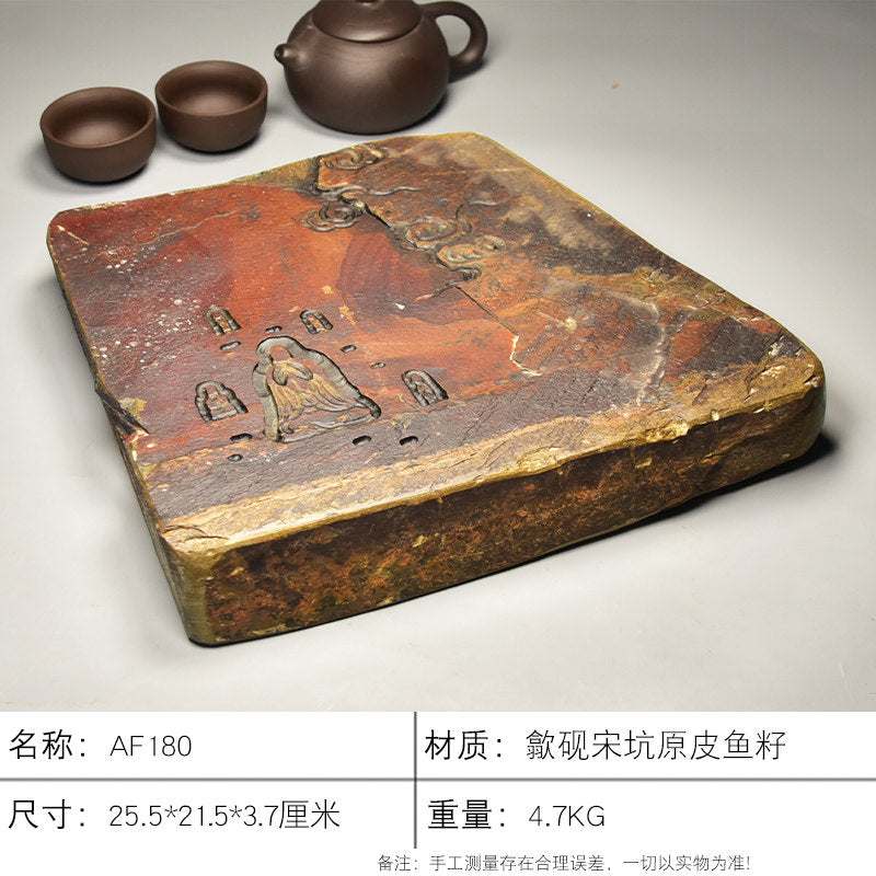 Handcrafted natural stone tea tray with intricate meditative carvings and rustic ochre tones for Gongfu tea ceremonies