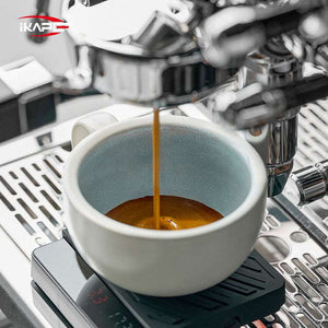 IKAPE Ceramic Coffee Cup 300ml with matte white exterior and glazed interior on oval saucer