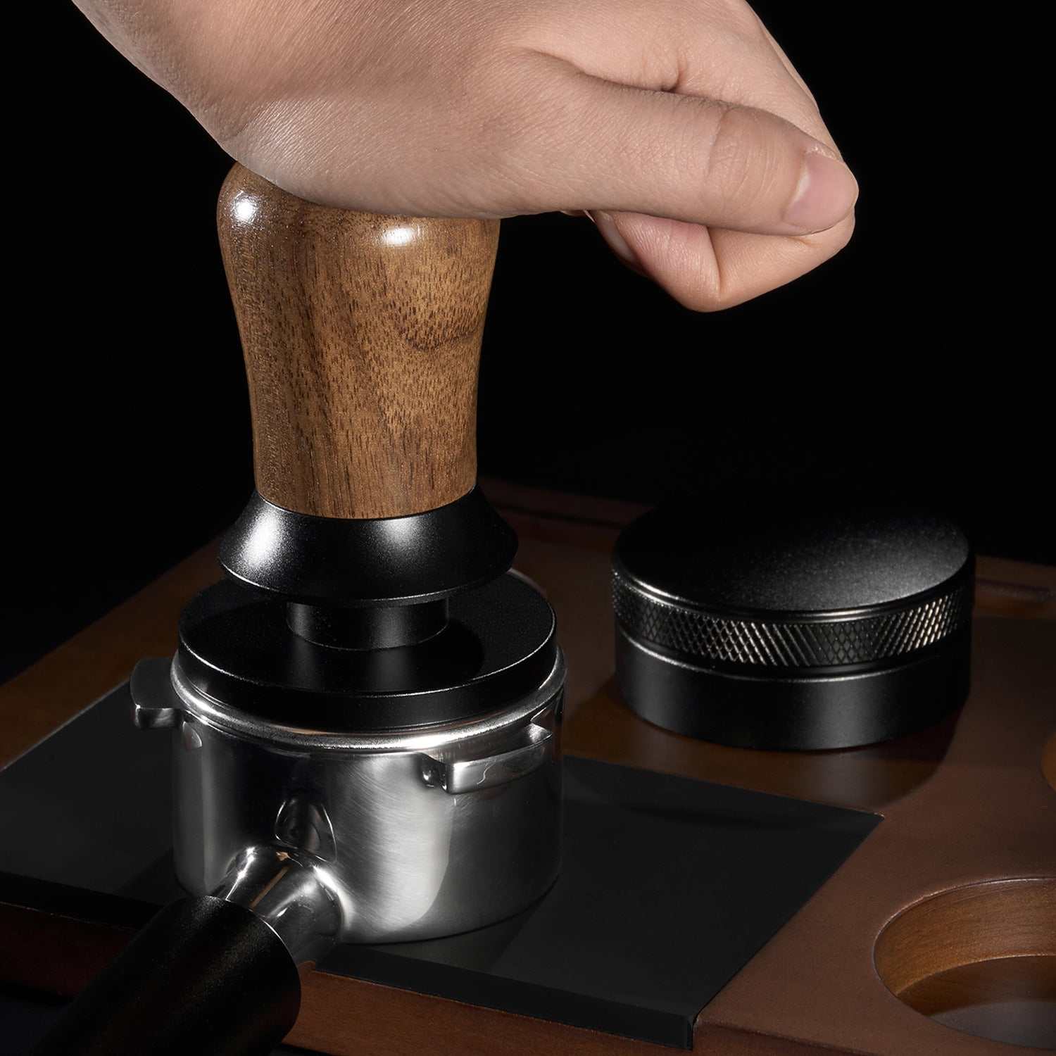 Espresso tamper with walnut wood handle and stainless steel ripple base for even coffee extraction