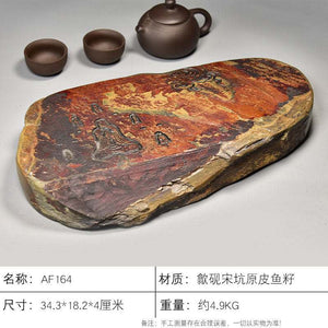 Handcrafted natural stone tea tray with meditative carvings and rustic ochre tones for Gongfu tea ceremony