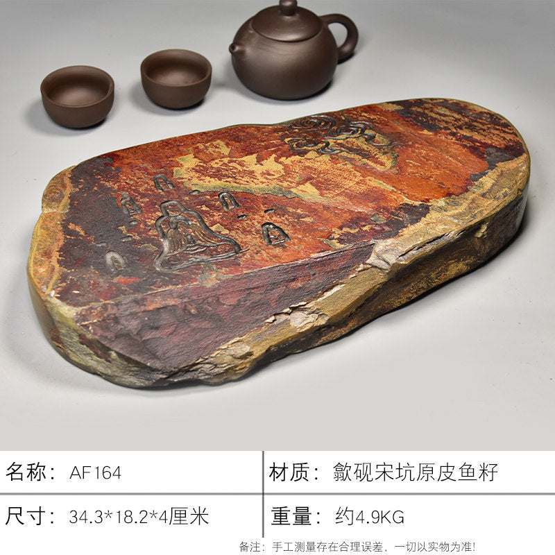 Handcrafted natural stone tea tray with meditative carvings and rustic ochre tones for Gongfu tea ceremony