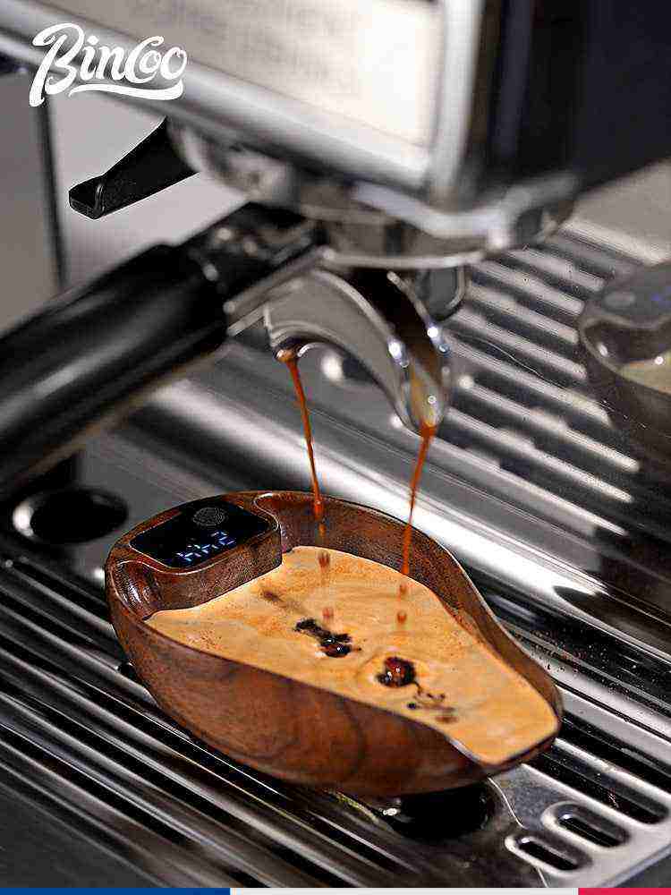 Luxury wooden drop-shaped electronic coffee scale with digital display under espresso machine.