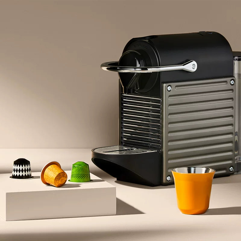 Orange Pixie espresso cup with coffee machine and capsules