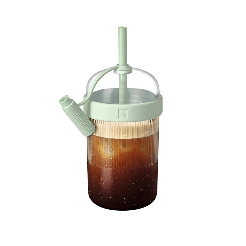Iced coffee shaker cup in light green on white background