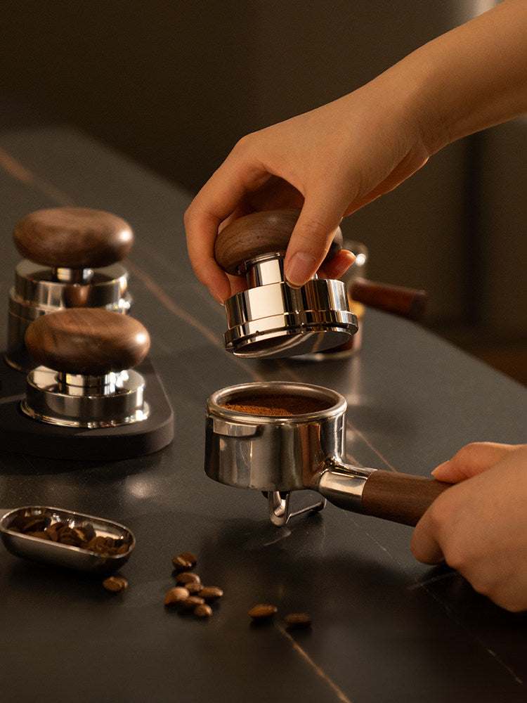 Timemore Wooden Espresso Tamper and Distributor Set with hardwood handles and stainless steel bases on a wooden stand