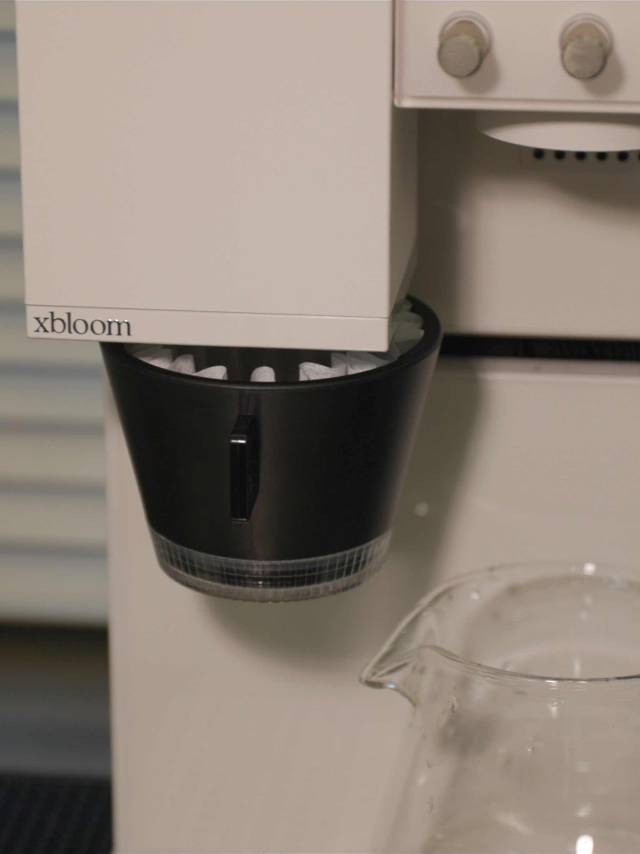 Macro shot of xBloom Studio professional dripper and integrated grinding outlet.
