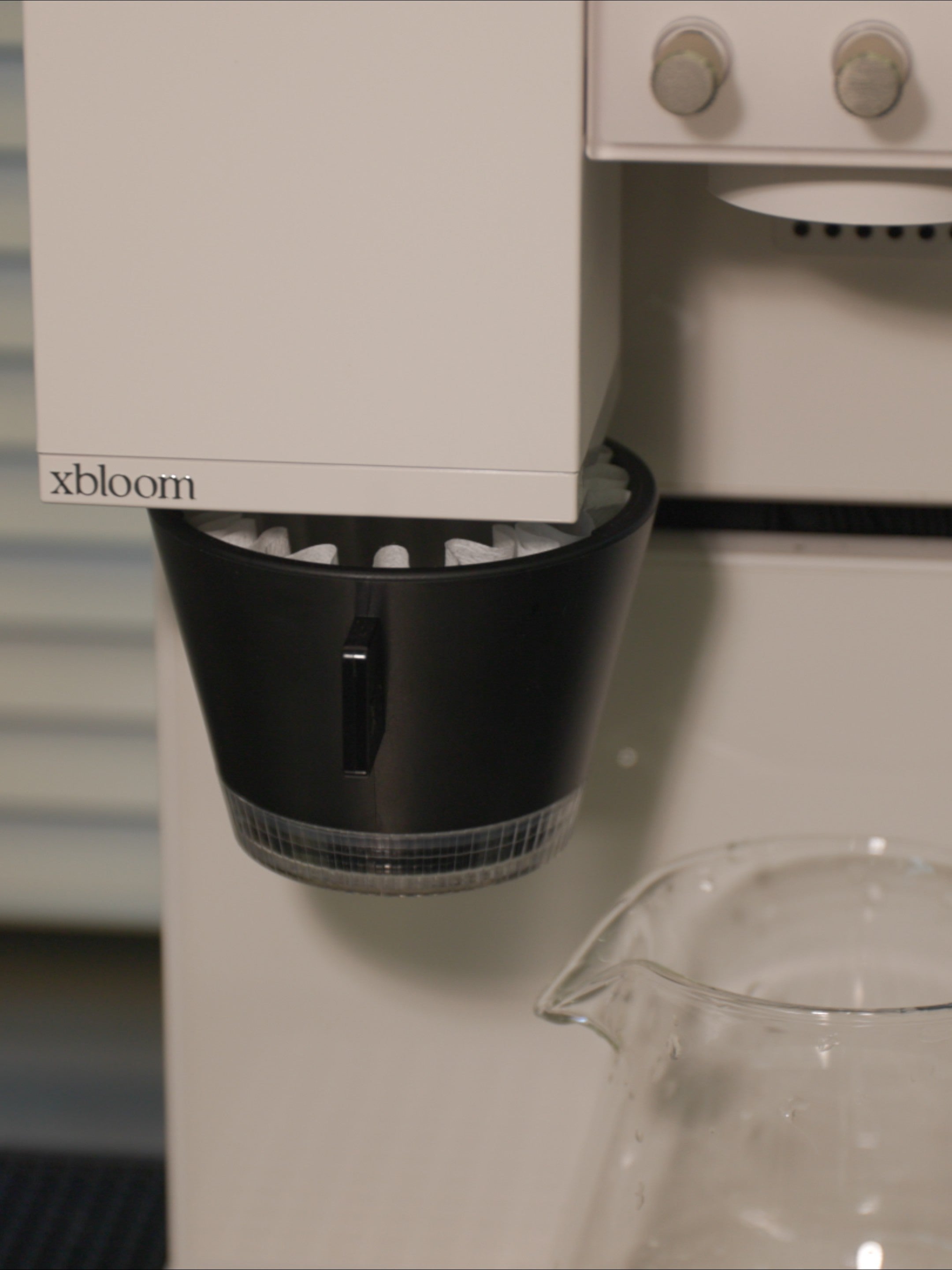 Macro shot of xBloom Studio professional dripper and integrated grinding outlet.