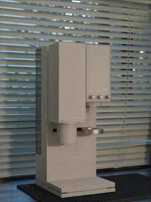 xBloom Studio white smart brewer in a natural light setting near a window.